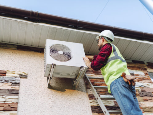 Service Technician repairing heat pump